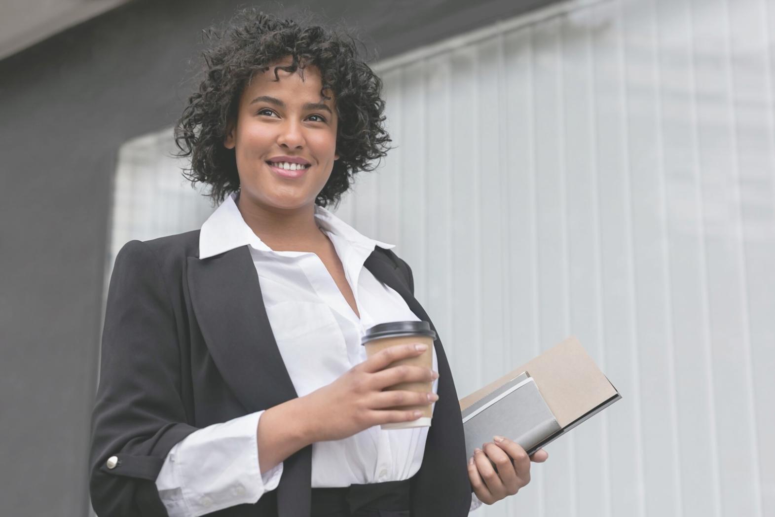 Person reviewing investment documents with coffee